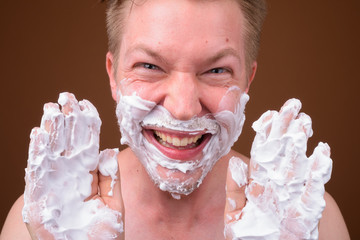 Face of young man shaving his face