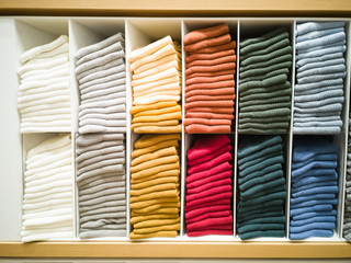 Multi-colored T-shirt folded in the lining of the shopping mall.