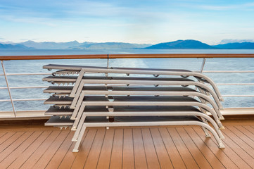 Fototapeta na wymiar Stacked lounge chairs, Lido deck of cruise ship, Inside Passage, BC, Canada.