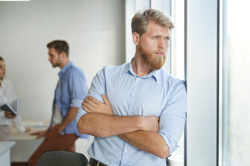 Portrait of a happy young casual businessman at office.