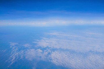 blue sky and white clouds with land from top view on air plain