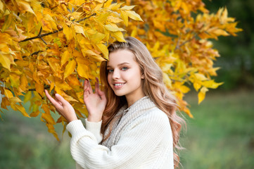 Beautiful girl walking outdoors in autumn.