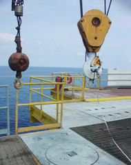 crane hoist, main and auxiliary hooks with safety latches and guiding sling on remote offshore...