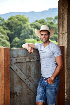 Portrait of cowboy posing in stable