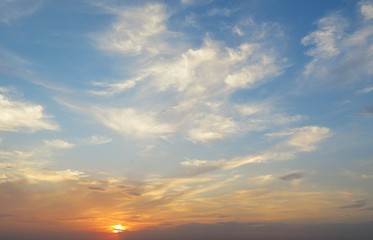Beautiful orange sunset over the field, the sun sets over the horizon 
