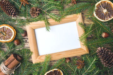 Creative layout made of Christmas tree branches with paper card note. Flat lay. Nature New Year concept.