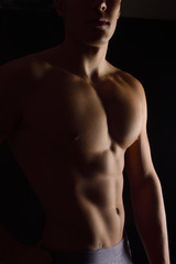 Fototapeta na wymiar naked body of a man on black background