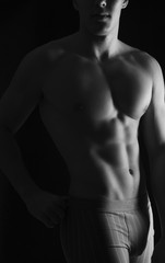 Fototapeta na wymiar naked body of a man on black background