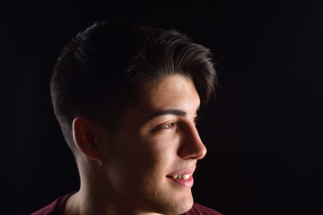 portrait of a young man on black background
