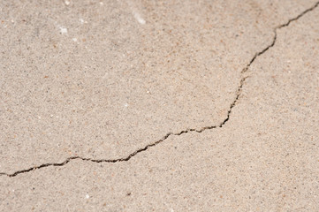 Plaster floor with cracks. Building requiring repair closeup.