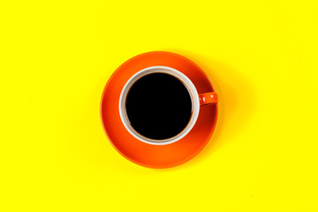 cup of coffee and saucer on color background