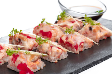 Black rectangle plate with sushi, isolated on white