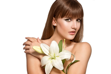 Beauty Spa Woman with perfect skin Portrait. Woman with lily flower. Skincare. Young Skin