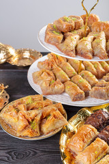 baklava with pistachio. turkish traditional delight on a dark wood background