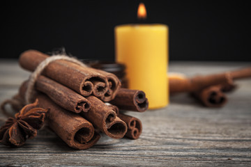 Cinnamon sticks on wooden background.