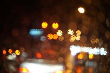 Rainy night traffic light - selective focus on the raindrop,abstract bokeh of light