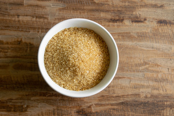 brown sugar in a bowl on wooden table background