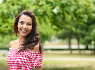Fototapeta premium Happy Young Woman in Gingham Off-Shoulder Top Outdoor Portrait