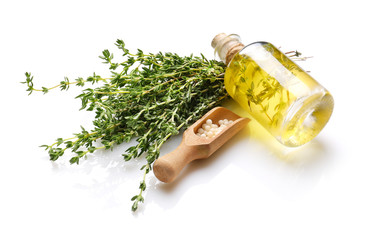 Bottle of essential oil with pills and thyme on white background - obrazy, fototapety, plakaty