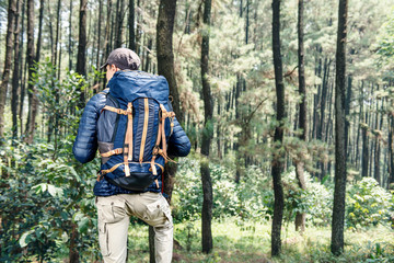 Rear view of asian traveler man with backpack