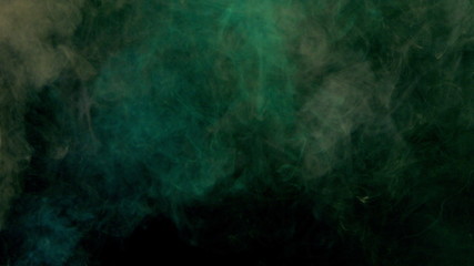 Obraz na płótnie Canvas orange and green bomb smoke on black background