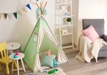 Fototapeta na wymiar Cozy play tent for kids in interior of room