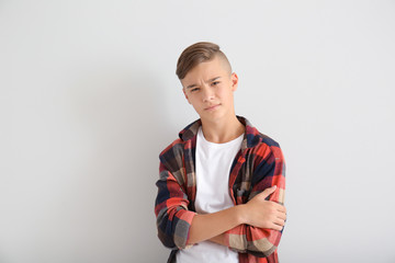 Frowning teenage boy on white background