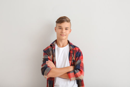 Confident teenage boy on white background