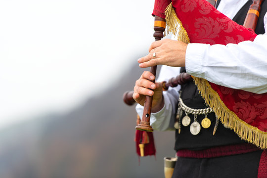 Playing the conramusa in an open space in the mountains
