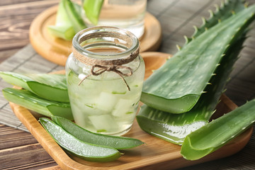 Jar of aloe vera juice on wooden tray