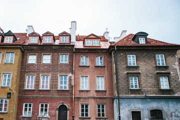 Beautiful street with traditional colorful houses in Warsaw in Poland.