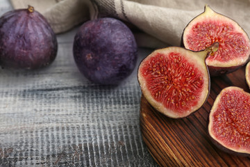 Fresh ripe figs on wooden table