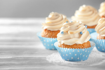 Delicious cupcakes on white table
