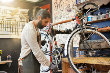 Man working in cycle repair shop