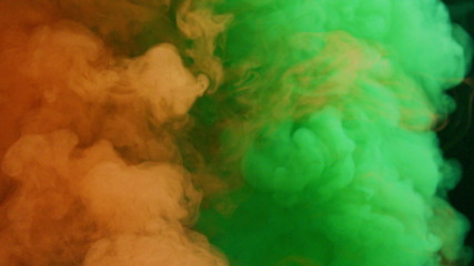 orange and green bomb smoke on black background