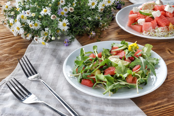 Plate with delicious watermelon salad on wooden table