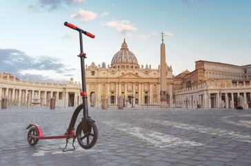 Red push scooters against the backdrop of the Vatican in the Roma, Italy. Horizontal.