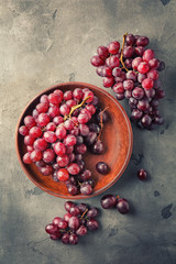 Plate with sweet grapes on grunge table
