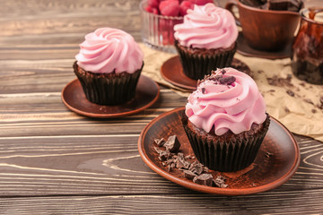 Tasty cupcakes on wooden table