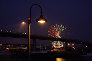 street lamp and ferris wheel in the night
