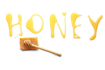 Word HONEY and wooden dipper on white background