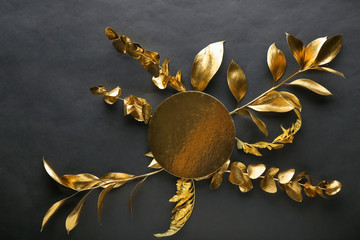 Obraz na płótnie Canvas Golden leaves with greeting card on black background
