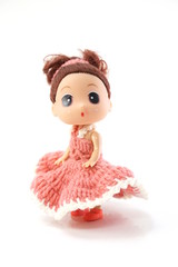 beautiful baby doll with pink dress isolated on white background