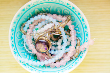 Natural mineral stone beads in decorative bowl