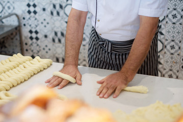 a man cooking turkish bagels (simit)