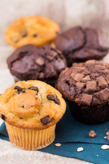 Homemade muffins with chocolate, vintage background.