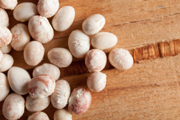 White beans close up on wood desk