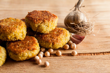 Fresh falafel balls on a wooden cutting board