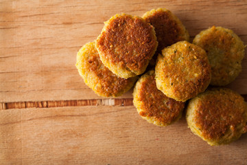 Fresh falafel balls on a wooden cutting board