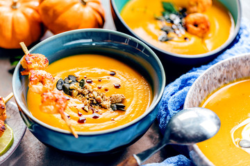 Roasted pumpkin and carrot soup with cream and pumpkin seeds 